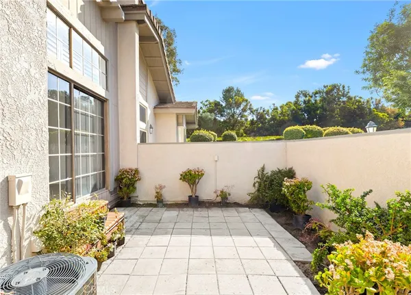 a view of a house with a backyard porch and sitting area