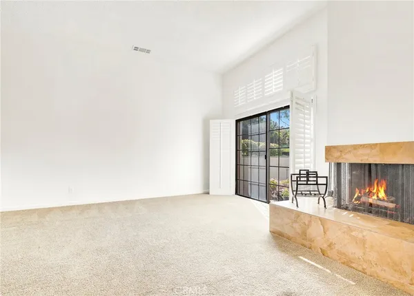 a view of an empty room with a fireplace