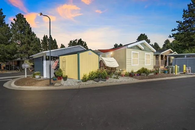 a front view of a house with a garden and yard
