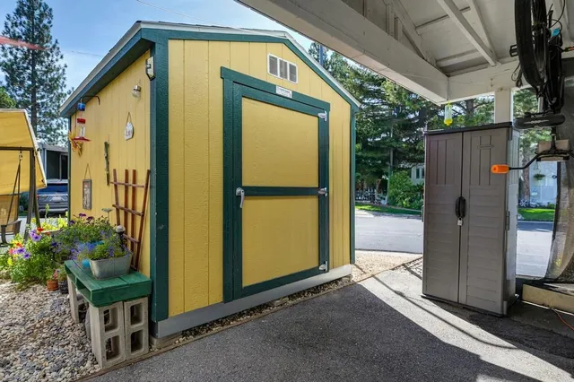 a view of a house with backyard and sitting area