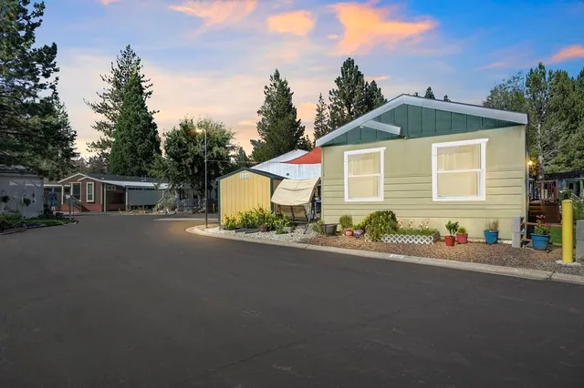 a front view of a house with a yard and a garage