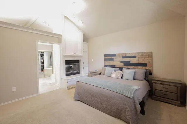 a large bedroom with a bed and a fireplace