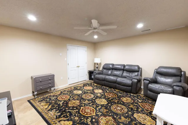 a living room with furniture and a rug