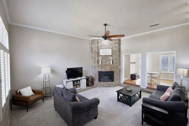 a living room with furniture a fireplace and a flat screen tv