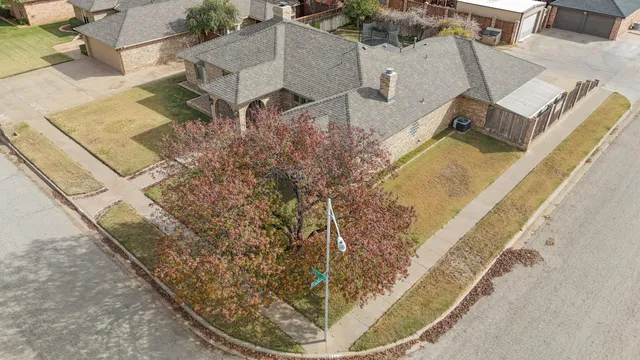 an aerial view of a house with a yard