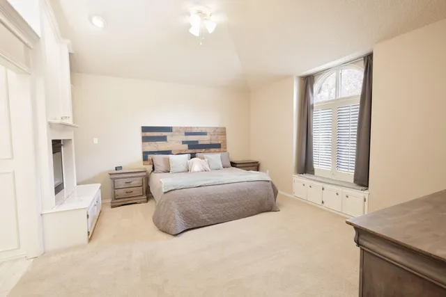 a bedroom with a large bed and a couch