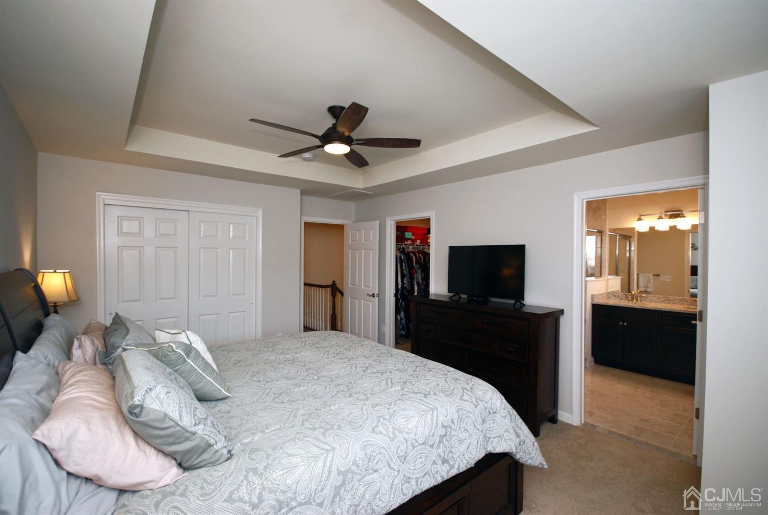 9 Flagger Lane Hamilton, NJ 08619 - Photo 14 of 24 a bedroom with a bed and a flat screen tv