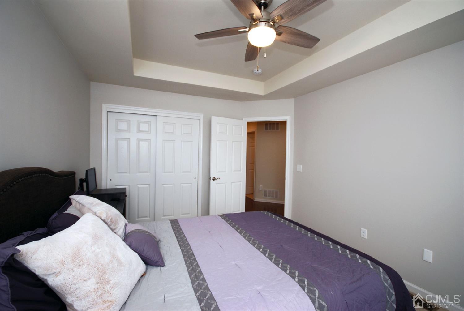 9 Flagger Lane Hamilton, NJ 08619 - Photo 18 of 24 a bedroom with a bed and a chandelier