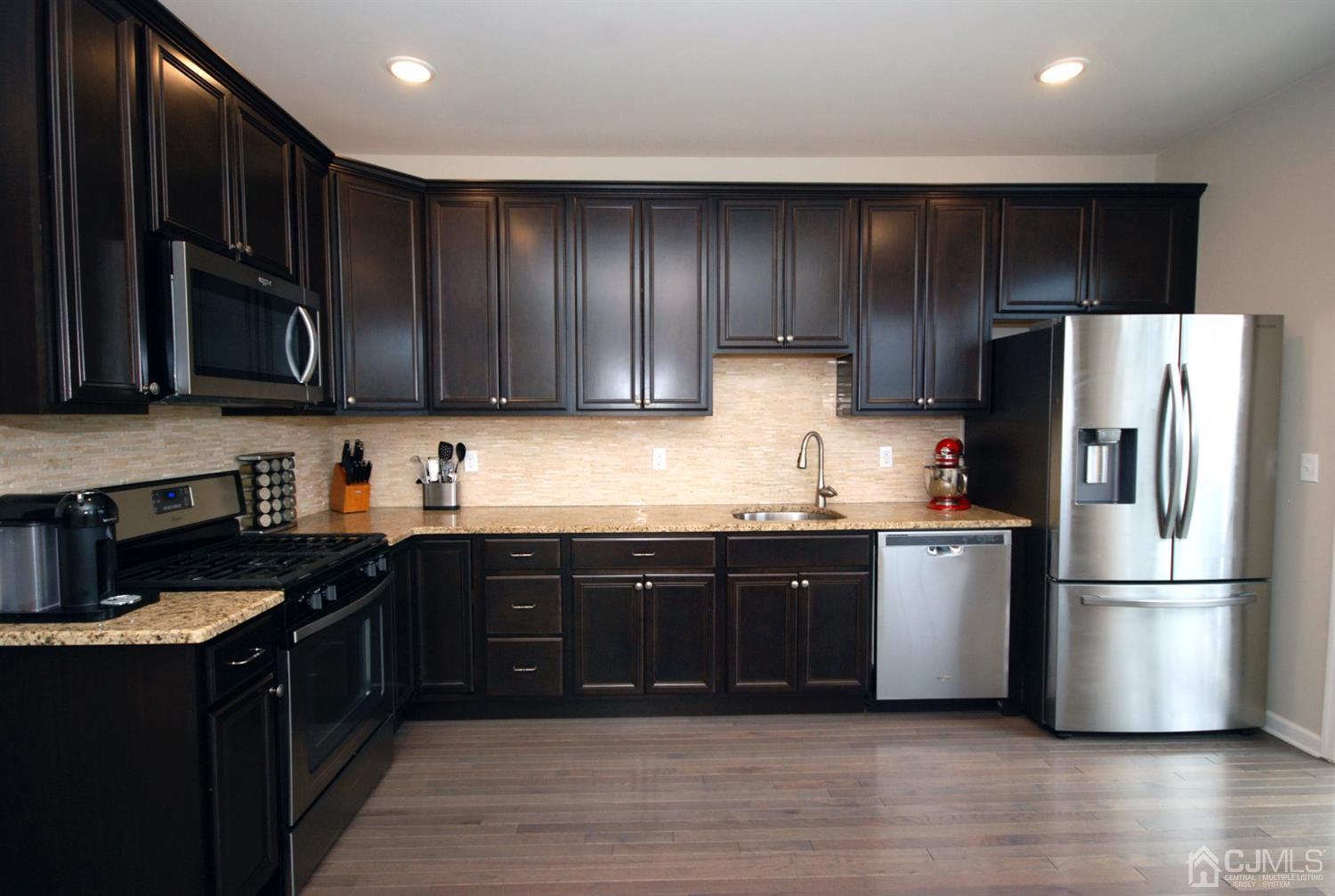 9 Flagger Lane Hamilton, NJ 08619 - Photo 7 of 24 a kitchen with wooden cabinets stainless steel appliances and a sink