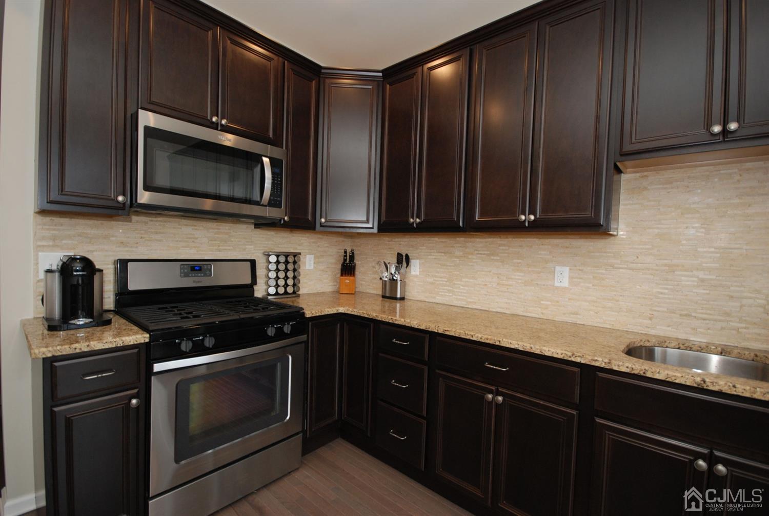 9 Flagger Lane Hamilton, NJ 08619 - Photo 8 of 24 a kitchen with granite countertop wooden cabinets and stainless steel appliances