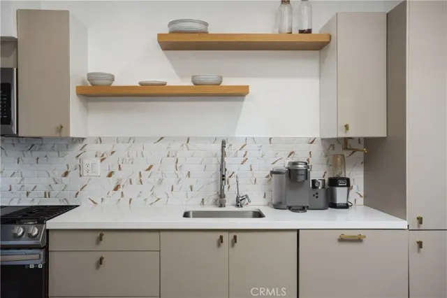 a kitchen with a sink and cabinets