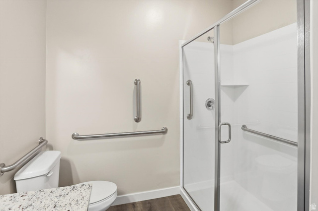 1838 West 300th Street South, Unit B Mapleton, UT 84664 - Photo 29 of 51 Shower enclosure with glass door, integrated shelving, and stainless steel grab bars