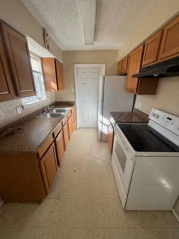 a kitchen that has a sink and a stove