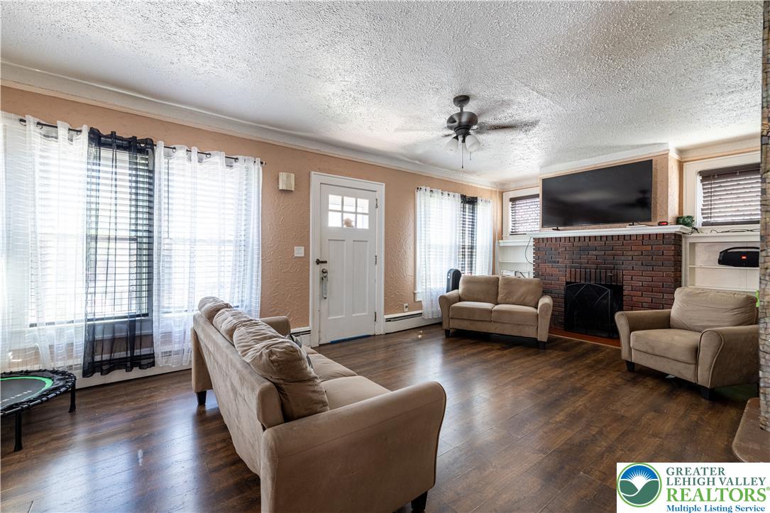 118 South 3rd Street Bangor, PA 18013 - Photo 4 of 33 This inviting living space features rich hardwood flooring and a classic brick fireplace.
