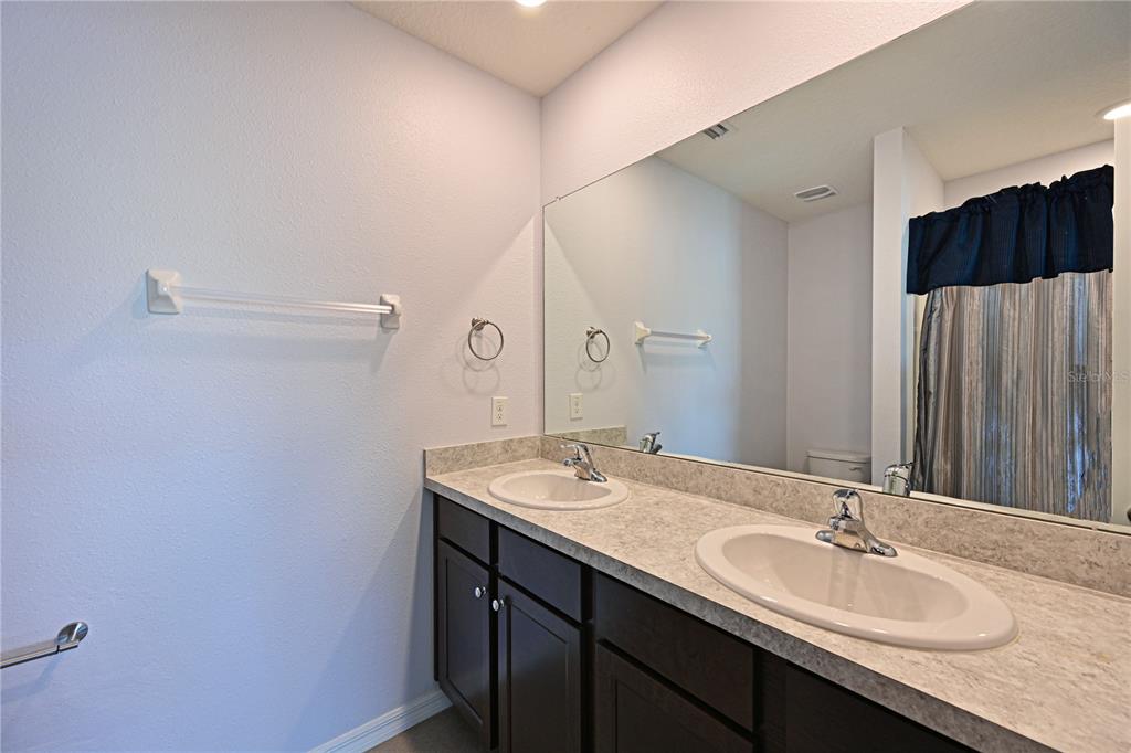 4919 Wedgeleaf Way Palmetto, FL 34221 - Photo 12 of 35 a bathroom with a sink and a mirror