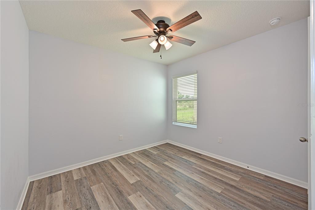 4919 Wedgeleaf Way Palmetto, FL 34221 - Photo 13 of 35 an empty room with a window and a ceiling fan