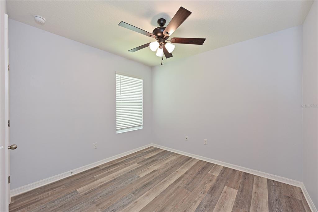 4919 Wedgeleaf Way Palmetto, FL 34221 - Photo 14 of 35 an empty room with a window and a fan