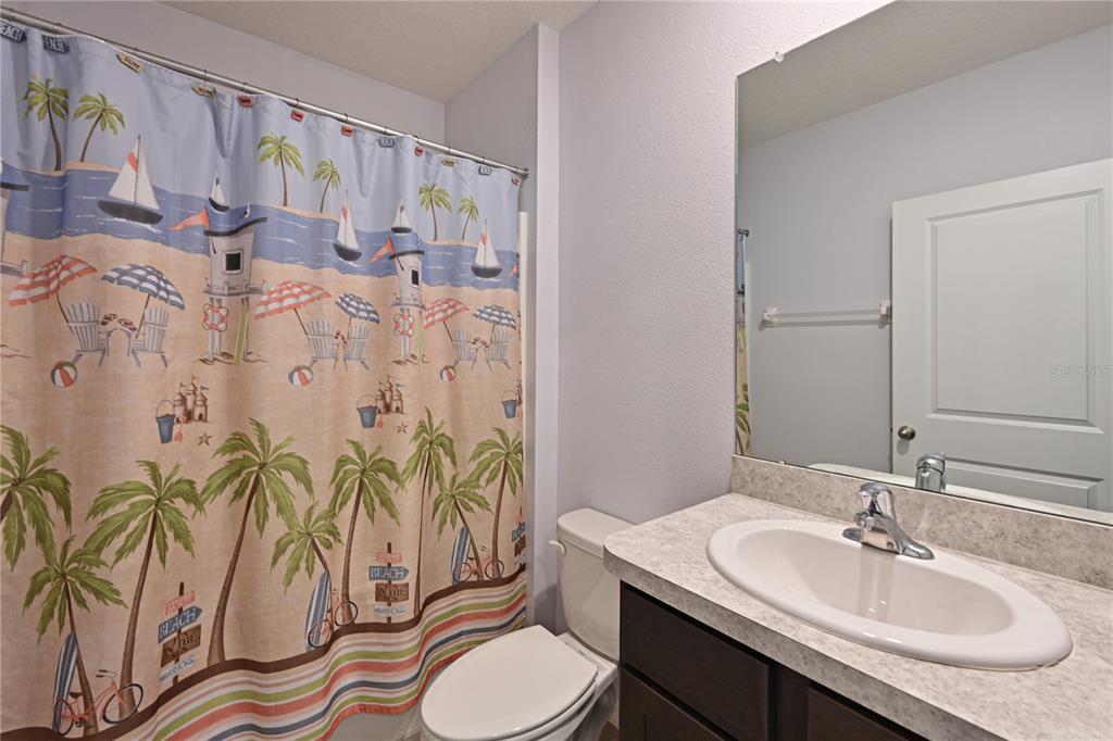 4919 Wedgeleaf Way Palmetto, FL 34221 - Photo 15 of 35 a bathroom with a granite countertop sink and a mirror