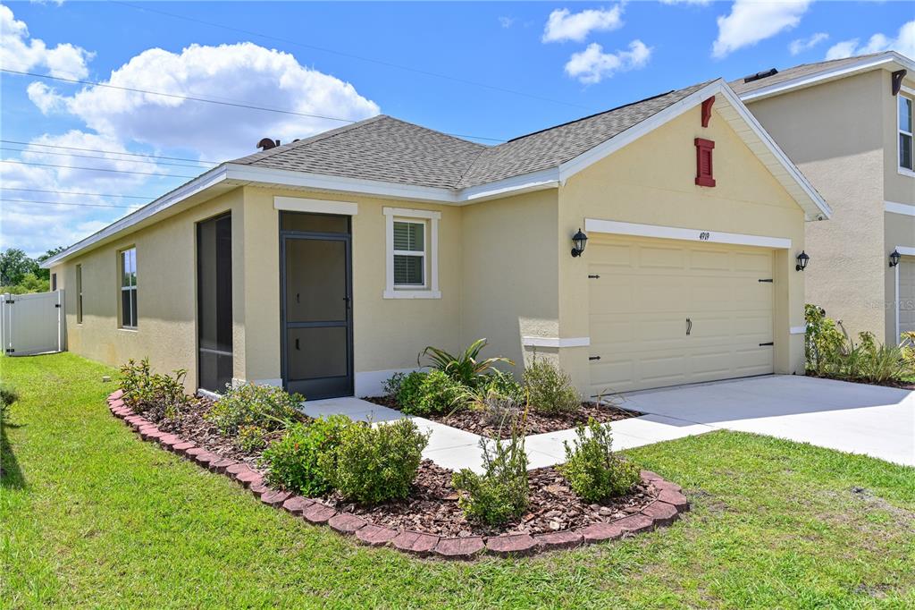 4919 Wedgeleaf Way Palmetto, FL 34221 - Photo 17 of 35 a front view of a house with a yard