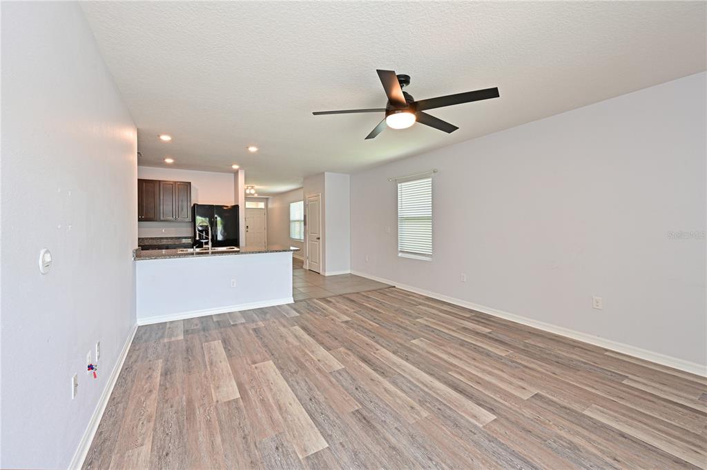 4919 Wedgeleaf Way Palmetto, FL 34221 - Photo 18 of 35 a view of a kitchen with a dishwasher and wooden floor