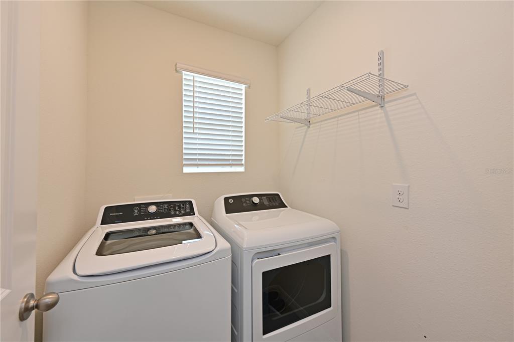 4919 Wedgeleaf Way Palmetto, FL 34221 - Photo 20 of 35 a utility room with dryer and washer