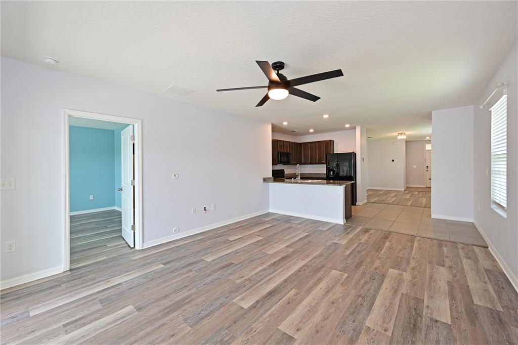 4919 Wedgeleaf Way Palmetto, FL 34221 - Photo 24 of 35 a view of a kitchen with a dishwasher and wooden floor