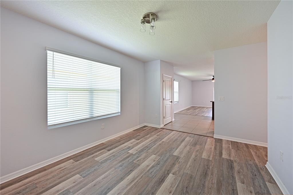 4919 Wedgeleaf Way Palmetto, FL 34221 - Photo 25 of 35 a view of an empty room with wooden floor and a window