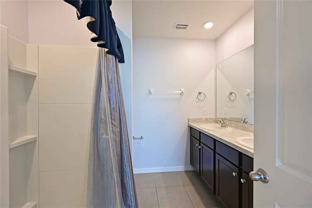 4919 Wedgeleaf Way Palmetto, FL 34221 - Photo 26 of 35 a bathroom with a granite countertop sink and a mirror