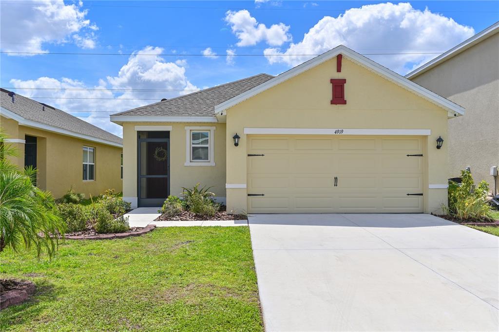 4919 Wedgeleaf Way Palmetto, FL 34221 - Photo 27 of 35 a front view of a house with garden