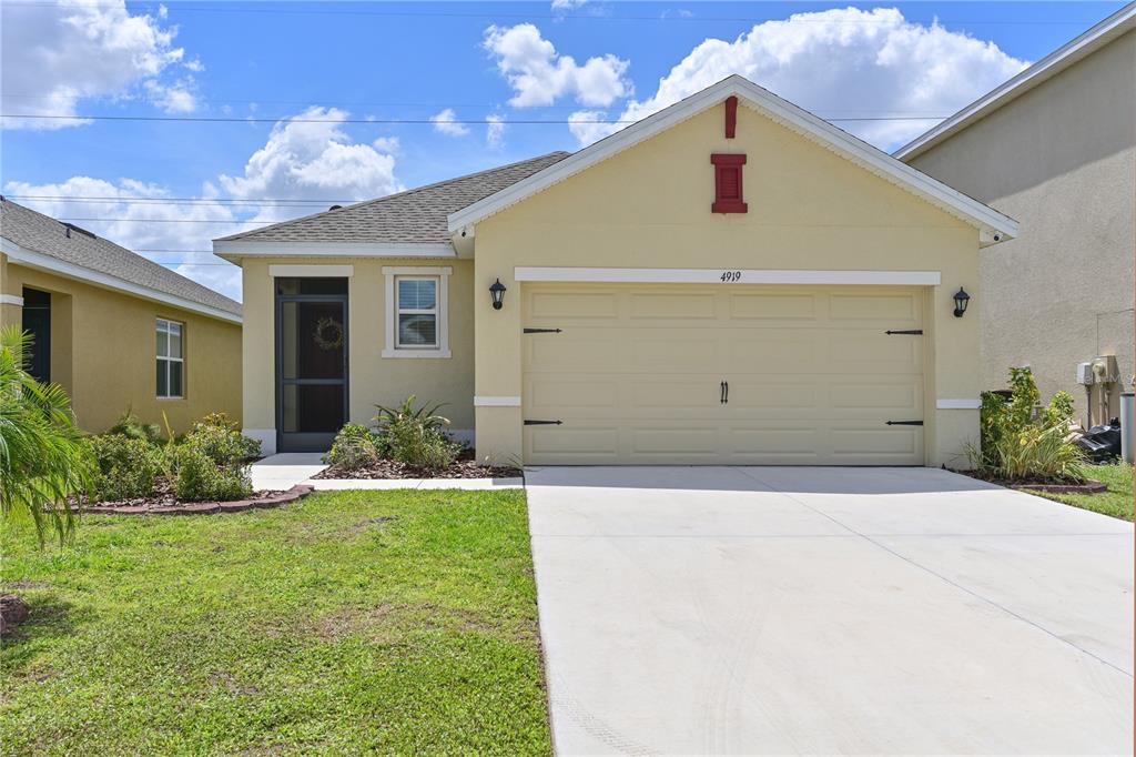 4919 Wedgeleaf Way Palmetto, FL 34221 - Photo 28 of 35 a front view of a house with a yard