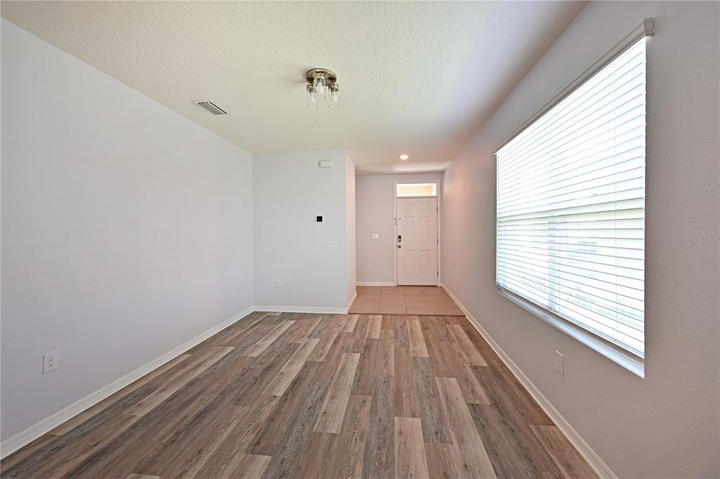 4919 Wedgeleaf Way Palmetto, FL 34221 - Photo 29 of 35 a view of an empty room with wooden floor and a window