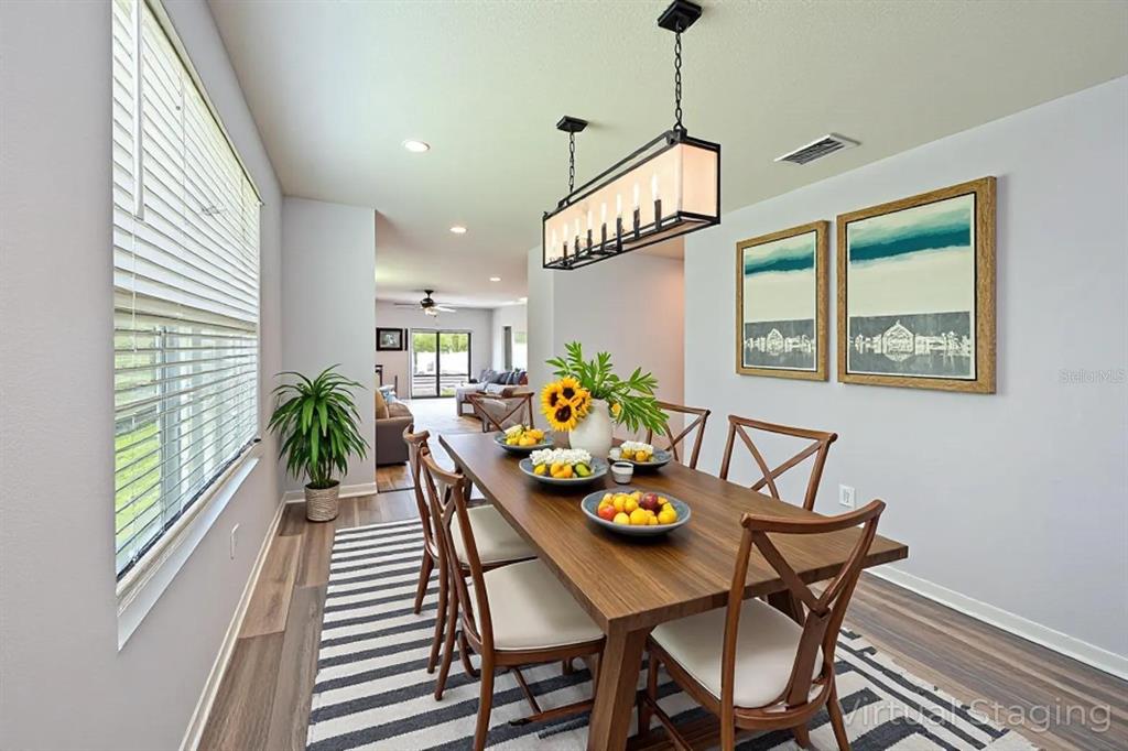 4919 Wedgeleaf Way Palmetto, FL 34221 - Photo 5 of 35 a view of a dining room with furniture window and wooden floor