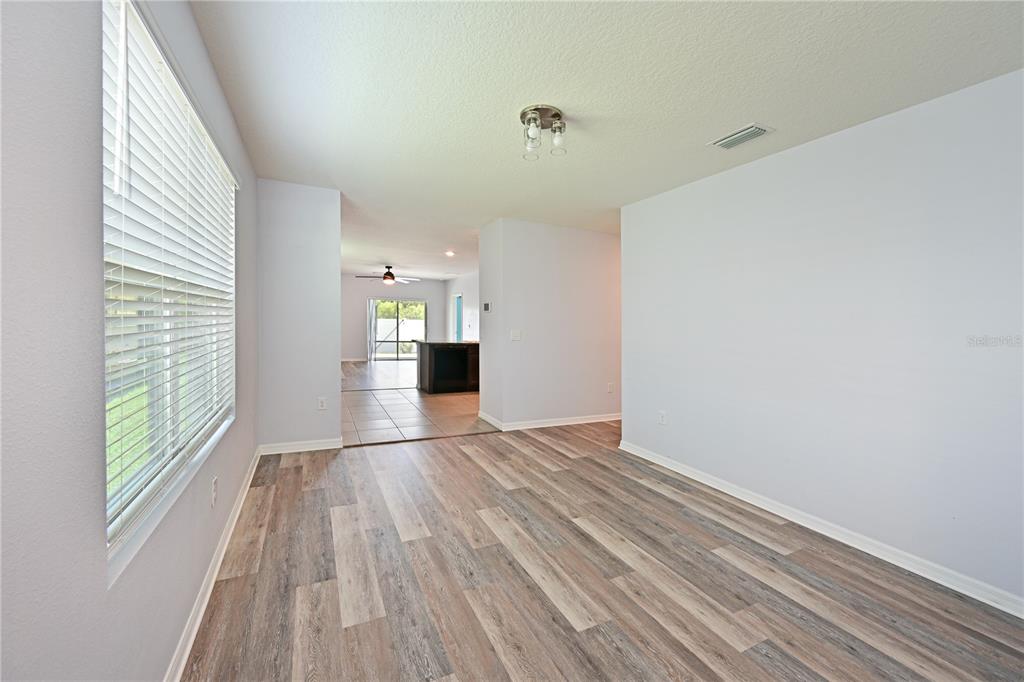 4919 Wedgeleaf Way Palmetto, FL 34221 - Photo 6 of 35 a view of empty room with wooden floor and fan