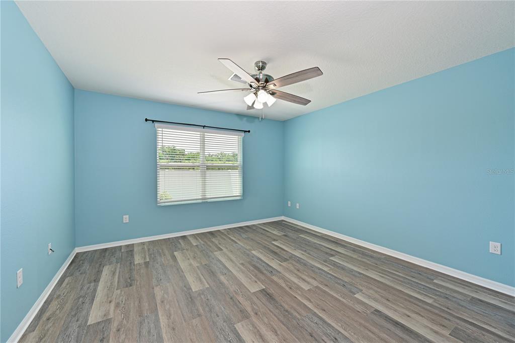 4919 Wedgeleaf Way Palmetto, FL 34221 - Photo 8 of 35 wooden floor in an empty room with a window