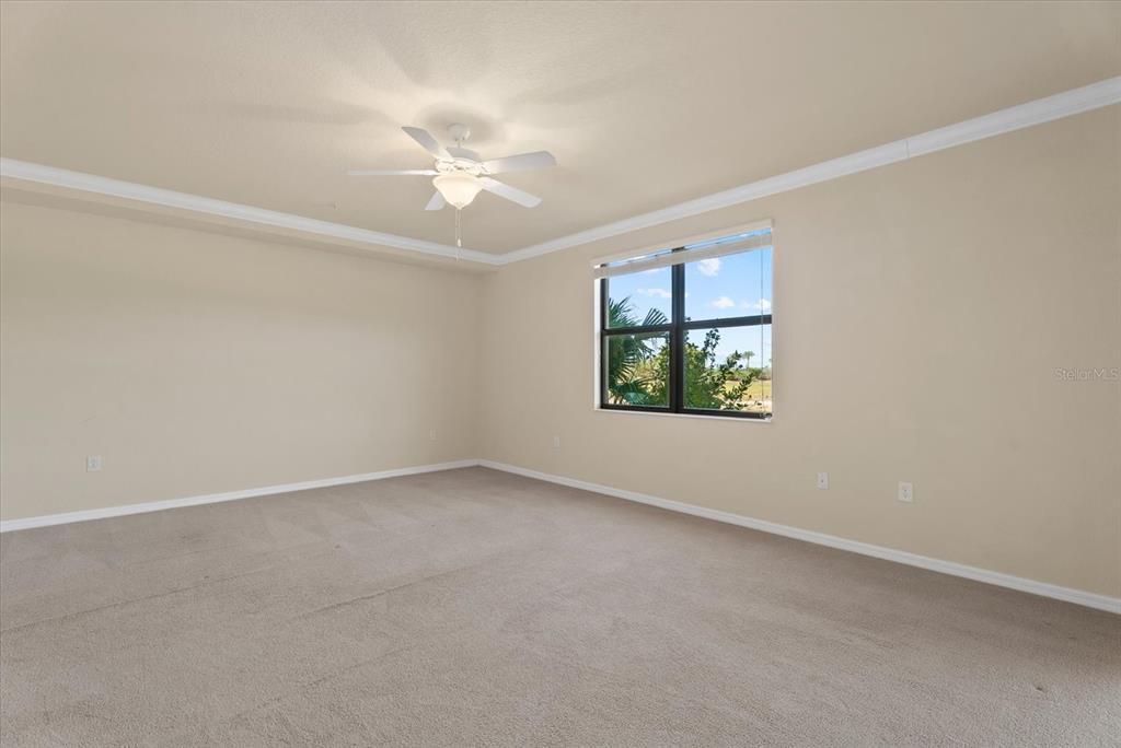 20080 Ragazza Circle, Unit 102 Venice, FL 34293 - Photo 23 of 49 an empty room with a window and a ceiling fan
