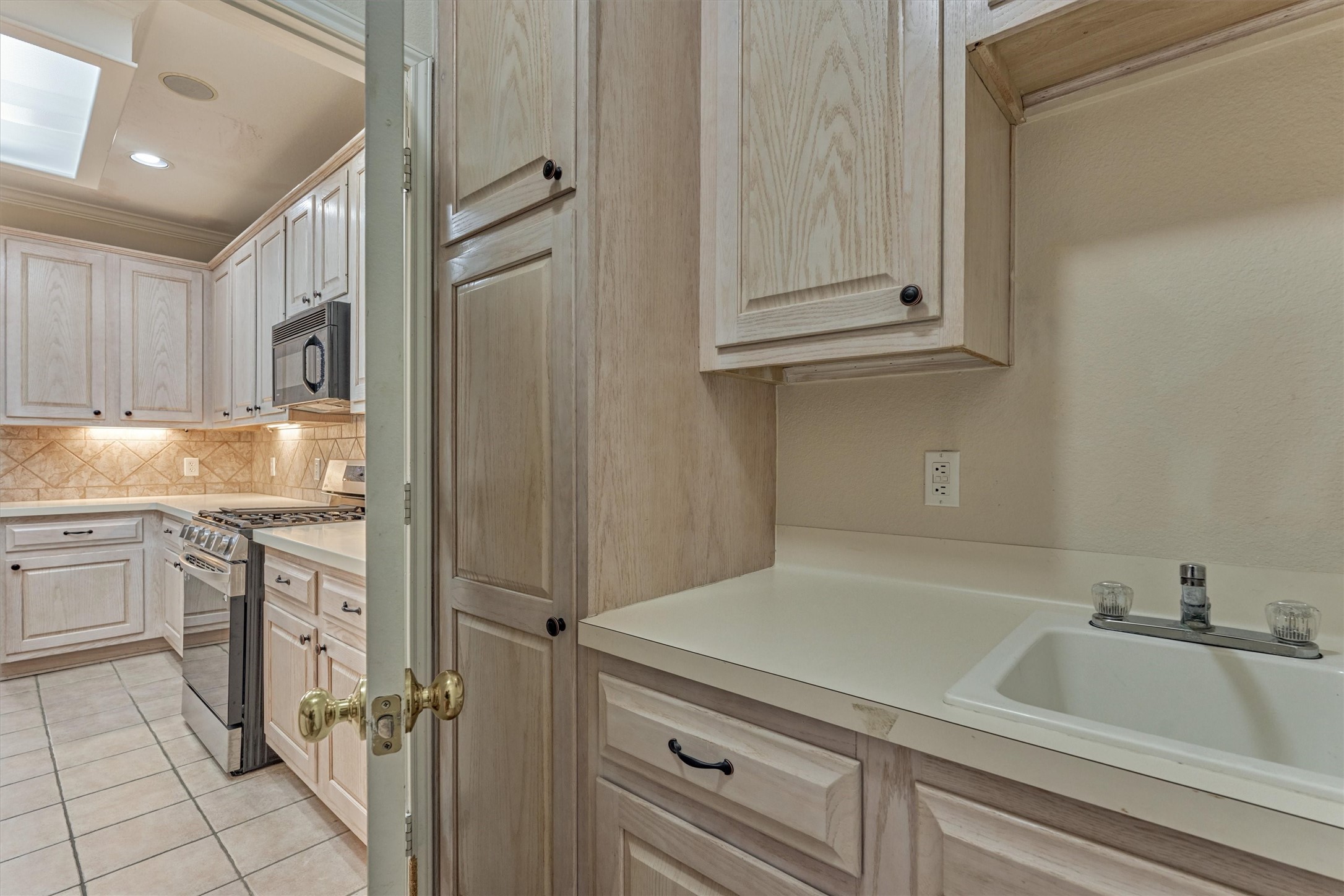14420 Walters Road, Unit 26 Houston, TX 77014 - Photo 16 of 45 Another view from the laundry room with a utility sink, more cabinetry, and ample counter space.