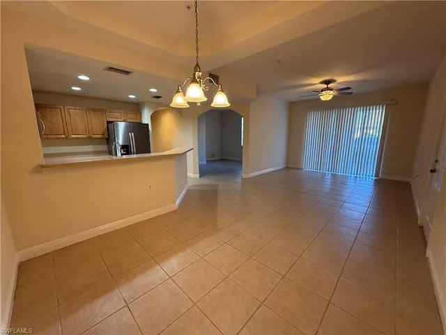 a view of a kitchen with a sink and chandelier
