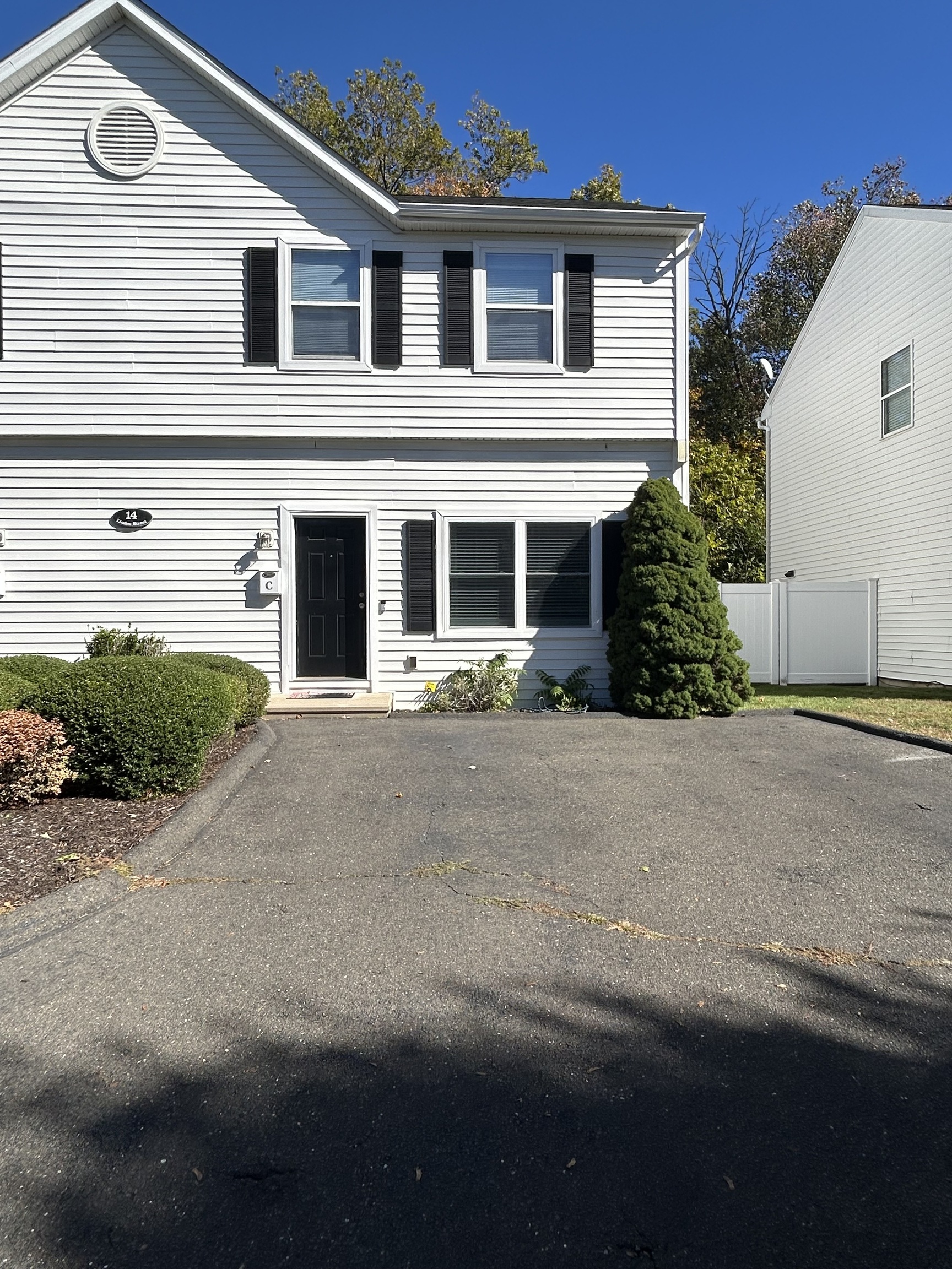 14 Linden Street, Unit C Norwalk, CT 06851 - Photo 1 of 16 a front view of a house with a yard and garage