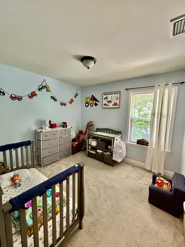 a bedroom with furniture and a window
