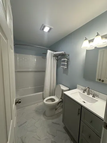 a bathroom with a sink toilet and shower