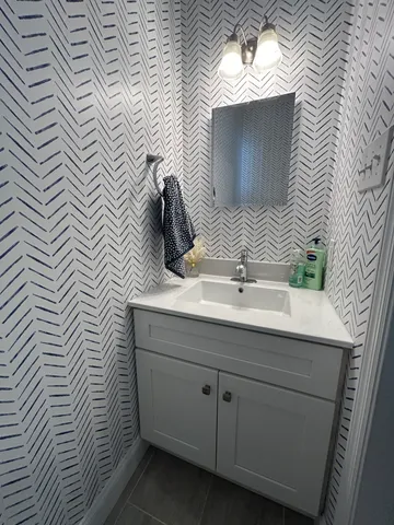 a bathroom with a sink a mirror and vanity