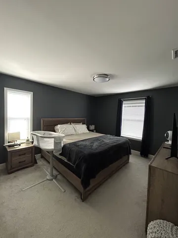 a bedroom with a bed and dresser