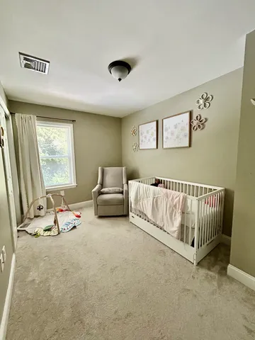 a bedroom with furniture and a window