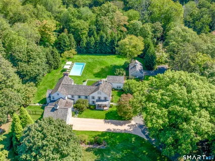 an aerial view of a house with yard swimming pool and outdoor seating