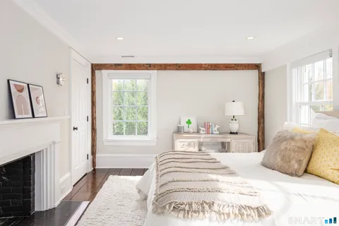 a bedroom with a large bed and a window