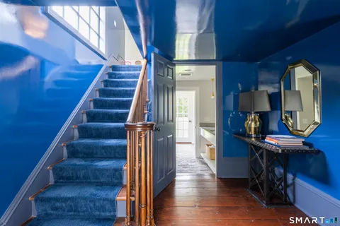 a view of entryway and hall with wooden floor