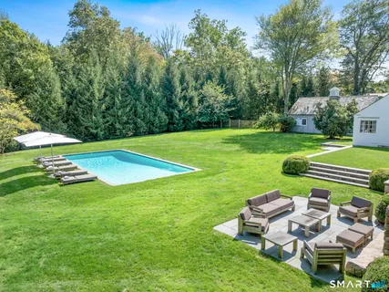 a view of a table and chairs in backyard