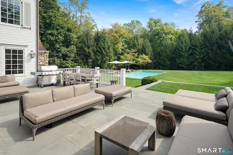 a view of a patio with couches and a fire pit