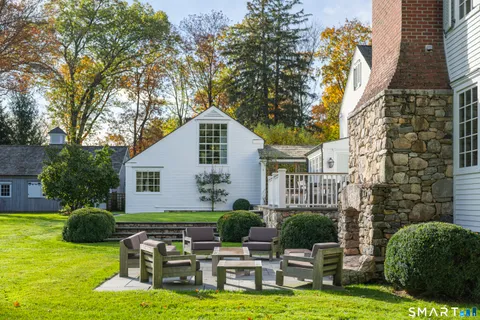 a house view with swimming pool and chairs