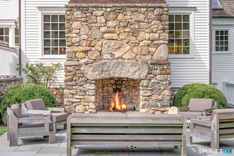a front view of a house with outdoor seating
